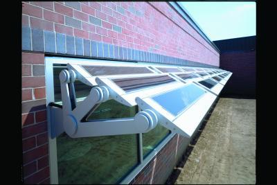 Up-close image of Kawneer Company's solar sunshade opened on a brick building
