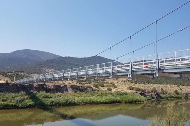 Newer bridge built with aluminum extrusion over a river in the Colorado wilderness