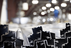 Extruded profiles in teh foreground with warehouse lights